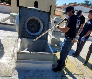 Pressure washing kitchen hood vent on roof